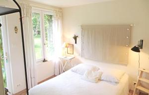 Saint-BranchsMaison de 2 chambres avec piscine partagee jardin amenage et wifi a Saint Branchs的一间卧室配有一张带白色床单的床和一扇窗户。