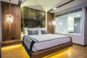 清迈宁漫居 - SHA Extra Plus的一间卧室配有床、窗户和灯