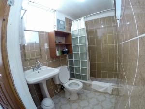 库尔克岛Chila's Accommodations的浴室配有卫生间、盥洗盆和淋浴。