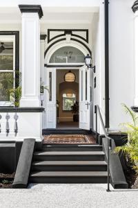 悉尼St Marks Randwick的白色房屋的入口,设有楼梯