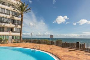 阿吉拉海滩Apartamento Soraya的一座位于一座海洋建筑前的游泳池