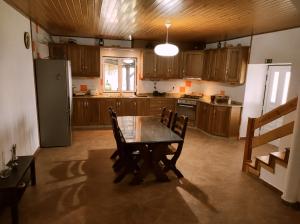 安旱斯达塞拉Quinta do Torgal - Alojamento Local的厨房配有桌椅和冰箱。