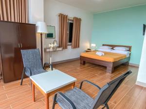 碧瑶美罗松树宾馆的酒店客房带一张床、一张桌子和椅子