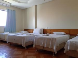 阿拉卡茹里特瑞酒店的客房设有2张带白色床单的床。