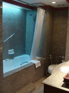 坤敬祡润芳尼孔敬酒店的带淋浴、浴缸和卫生间的浴室