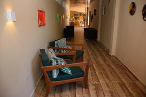 嘎林海斯港Pousada Velosmar的走廊上设有两把椅子和枕头