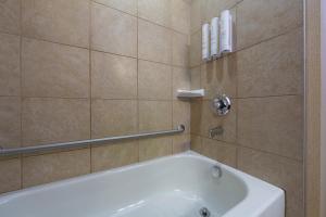 考特尼Bayview Hotel的浴室配有白色浴缸和淋浴。