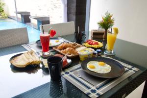 罗威那布鲁克2号别墅的包括鸡蛋、面包和饮料的早餐桌