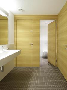 施库尔Scuol Youth Hostel的浴室配有卫生间、盥洗盆和淋浴。