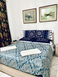 索马伦巴多CASA DEI FIORI的卧室配有蓝色和白色的床和2个枕头