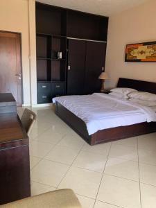 库塔法特瑜吉别墅酒店的一间卧室配有一张大床和木制床头板