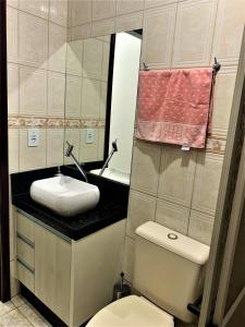 邦比尼亚斯烟火度假屋的一间带卫生间、水槽和镜子的浴室