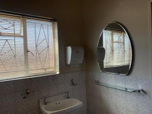 弗里尼欣Happy Living Guesthouse的一间带水槽和镜子的浴室