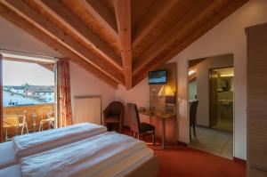 塞斯豪普特斯蒂尔夫酒店的一间卧室配有一张床、一张书桌和一个窗户。