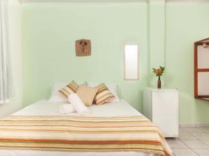 阿拉亚尔达茹达Pousada Recanto do Mucugê的一间卧室配有带条纹毯子的床