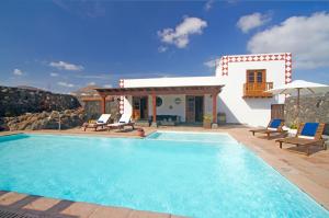 蒂亚斯卡萨卢拉英雄度假屋的一座带游泳池和房子的别墅