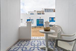 塞博河畔卡莱塔El Sombrerito 4的享有大楼景致的客房内的桌椅