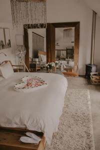 Rev EstatesQambathi Mountain Lodge的一间卧室配有一张白色大床,床上有鲜花