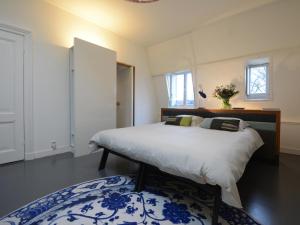 奈梅亨海特布劳乌尔早餐加卧室旅馆的卧室配有床和蓝白色地毯。