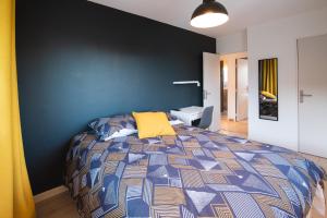 方黛涅Les chambres du Vercors - Parking Free Fibre Netflix的一间卧室配有一张蓝色墙壁的床