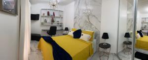 安格拉杜斯雷斯Charme Comforto Beira Mar的一间卧室配有黄色的床和两把椅子