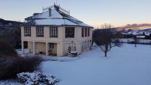 Palau-de-CerdagneLe petit manoir de Palau的白房子,地面上积雪