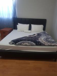 开普敦SALAMA LODGE的一张大床,配有黑色床头板和白色枕头