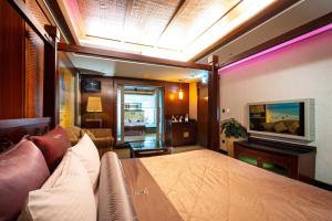台北印石时尚旅馆的客房设有床、沙发和电视。