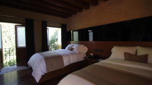 莫雷利亚卡萨马德罗精品酒店的一间卧室设有两张床和窗户。