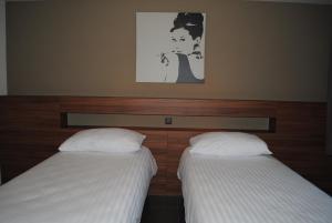 Hotel Du Soleil客房内的一张或多张床位