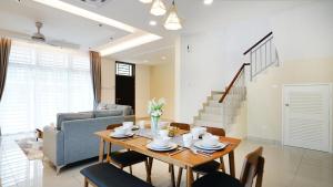 迪沙鲁Desaru Exclusive Elegant theme by Joyfully 2M8的客厅配有桌椅和沙发