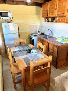 德尔迪阿布罗角Complejo Vidas del Mar的厨房配有桌子、水槽和冰箱