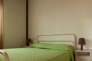 滨海库普拉La casa de Rocche的卧室内的一张带绿色棉被的床