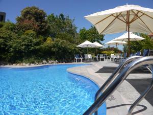 博迪利奈斯库图玛苏伽第1号公寓酒店的一个带滑梯和遮阳伞的游泳池