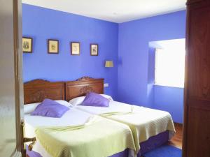 库迪列罗H Casona Selgas de Cudillero的一间卧室设有两张带蓝色墙壁的床