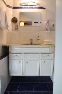 鲁斯特艾慈布里克宾馆的浴室设有白色水槽和镜子