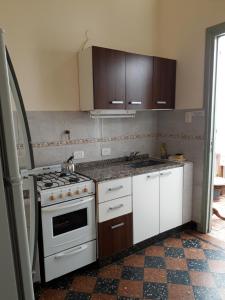 布宜诺斯艾利斯CAsA ARTIGAS 5684的厨房配有炉灶和白色橱柜。