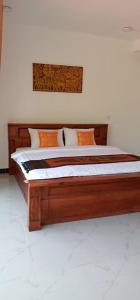 暹粒Khun Pich Apartments的配有一张大型木制床的客房内
