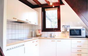 Bovenwezet3 Bedroom Gorgeous Home In Rekem-lanaken的厨房配有白色橱柜和微波炉