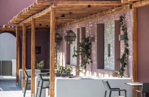 佩里沃罗Terra Nera Suites的一间带桌椅和粉红色墙壁的用餐室