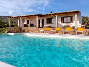 圣帕特雷拉La Sima villa con piscina vista mare San Pantaleo Sardegna的房屋前有游泳池的房子