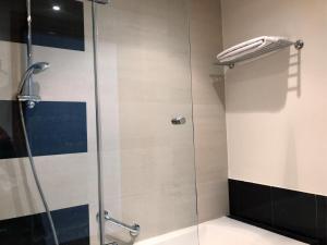 拉巴特Le Pietri Urban Hotel的浴室里设有玻璃门淋浴