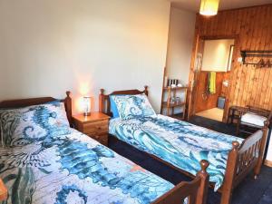 瑟索Windhaven Camping and B&B的一间卧室配有两张床和一张带台灯的桌子