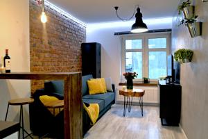 科希切日纳LOFT MAŁY的客厅设有蓝色的沙发和砖墙