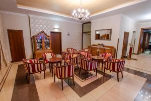 特普利采乔瓦尼贾科莫酒店的一间用餐室,配有红色的桌椅和吊灯