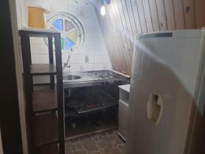 乌巴图巴Chalés Monções的小厨房配有炉灶和冰箱