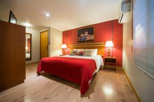 格拉玛多Hotel Boutique Britanico的一间卧室配有一张红色墙壁的床
