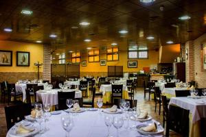 Aldea del FresnoHotel Rural El Jardin的用餐室配有桌椅和白色的桌布