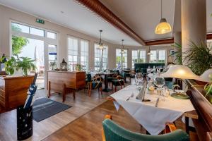 巴特Sur la Mer - Pension Garni的餐厅设有桌椅和窗户。