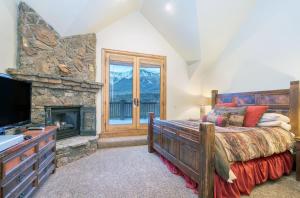特柳赖德Adams Ranch Rd - 249的一间卧室设有一张大床和一个壁炉